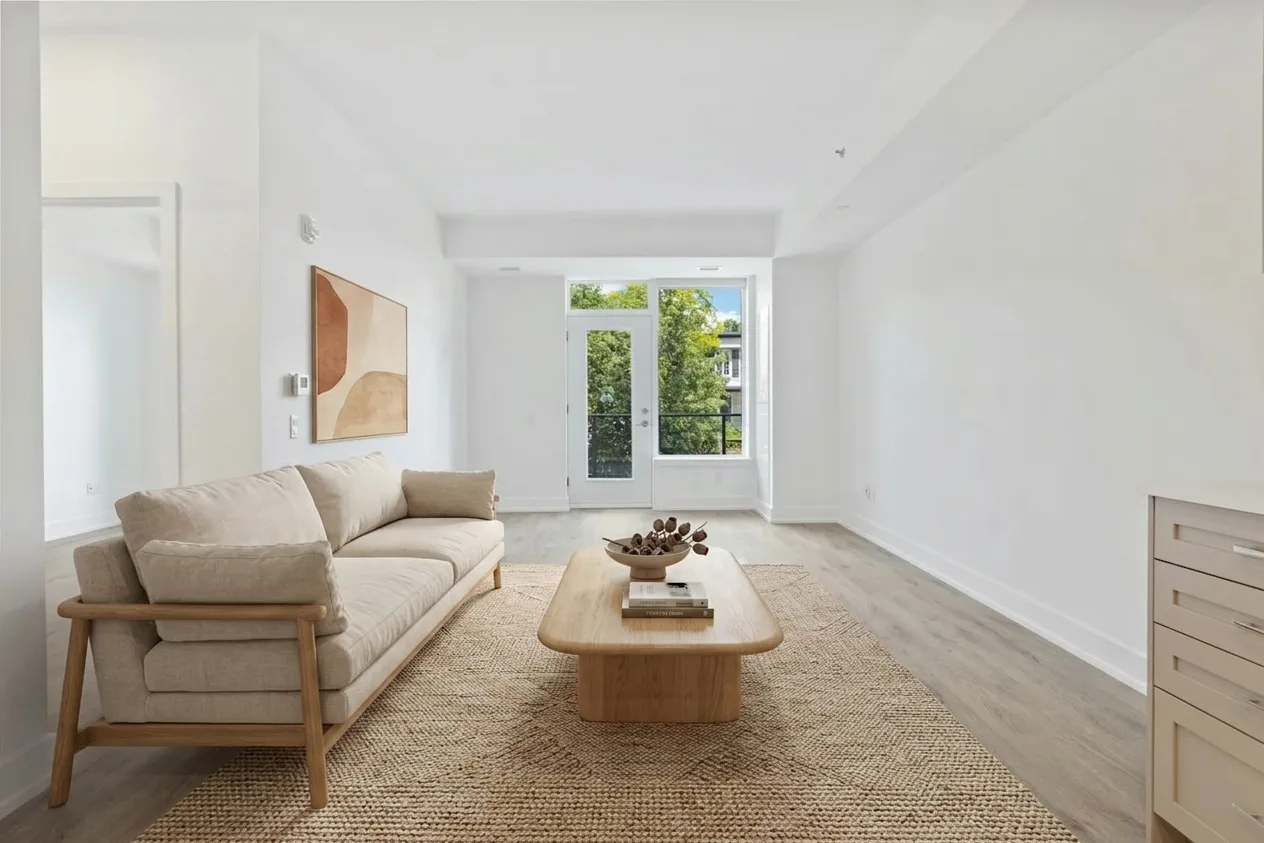 Living room virtually staged with a sofa, rug and coffee table generated by Kelvio Room Visualiser